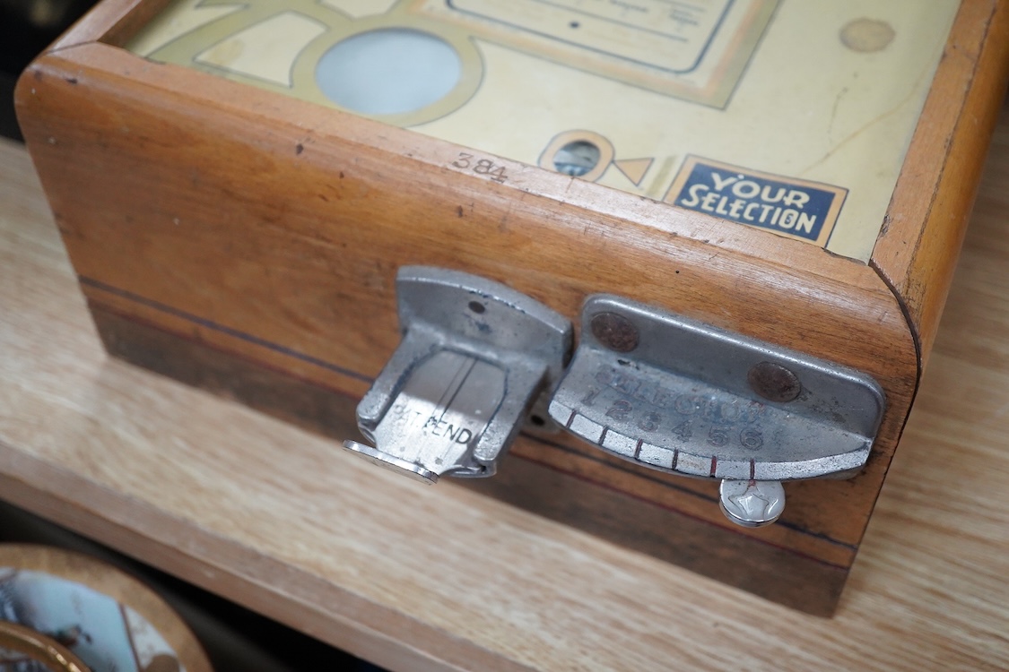 A ‘Select-Em’ table top pinball style dice game in a teak frame dated 1933, with Board of Equalization sales tax permit label for the State of California, 26cm wide, 35.5cm deep, 12.5cm high